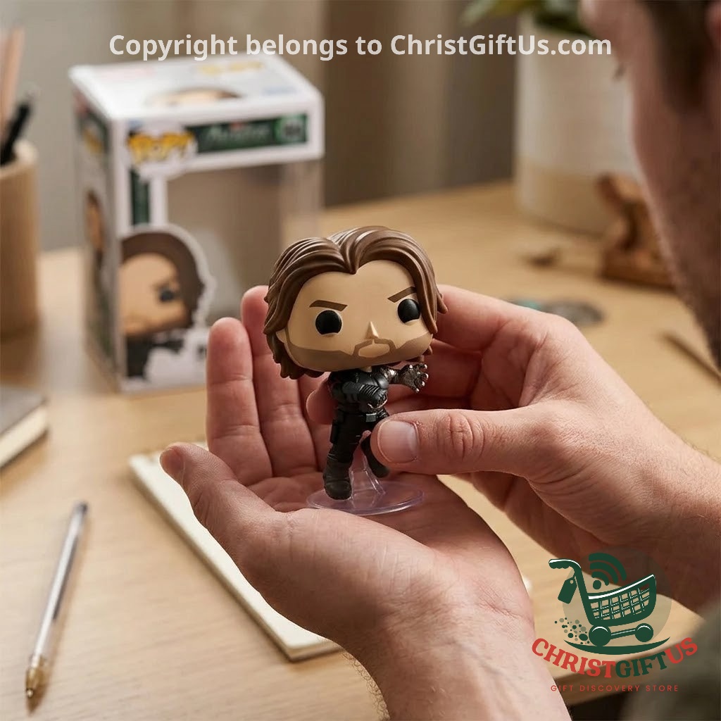 Hand holding the Bucky Barnes figure with metal arm