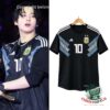 Black Argentina number 10 jersey on a hanger beside a stage photo