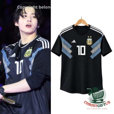 Black Argentina number 10 jersey on a hanger beside a stage photo
