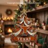 Texas Longhorns Christmas tree ornament hanging by a fireplace